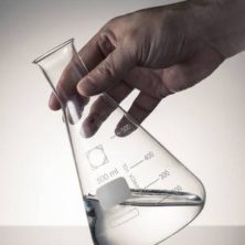 A Man Holding Sodium Bicarbonate Solution in a Conical Flask